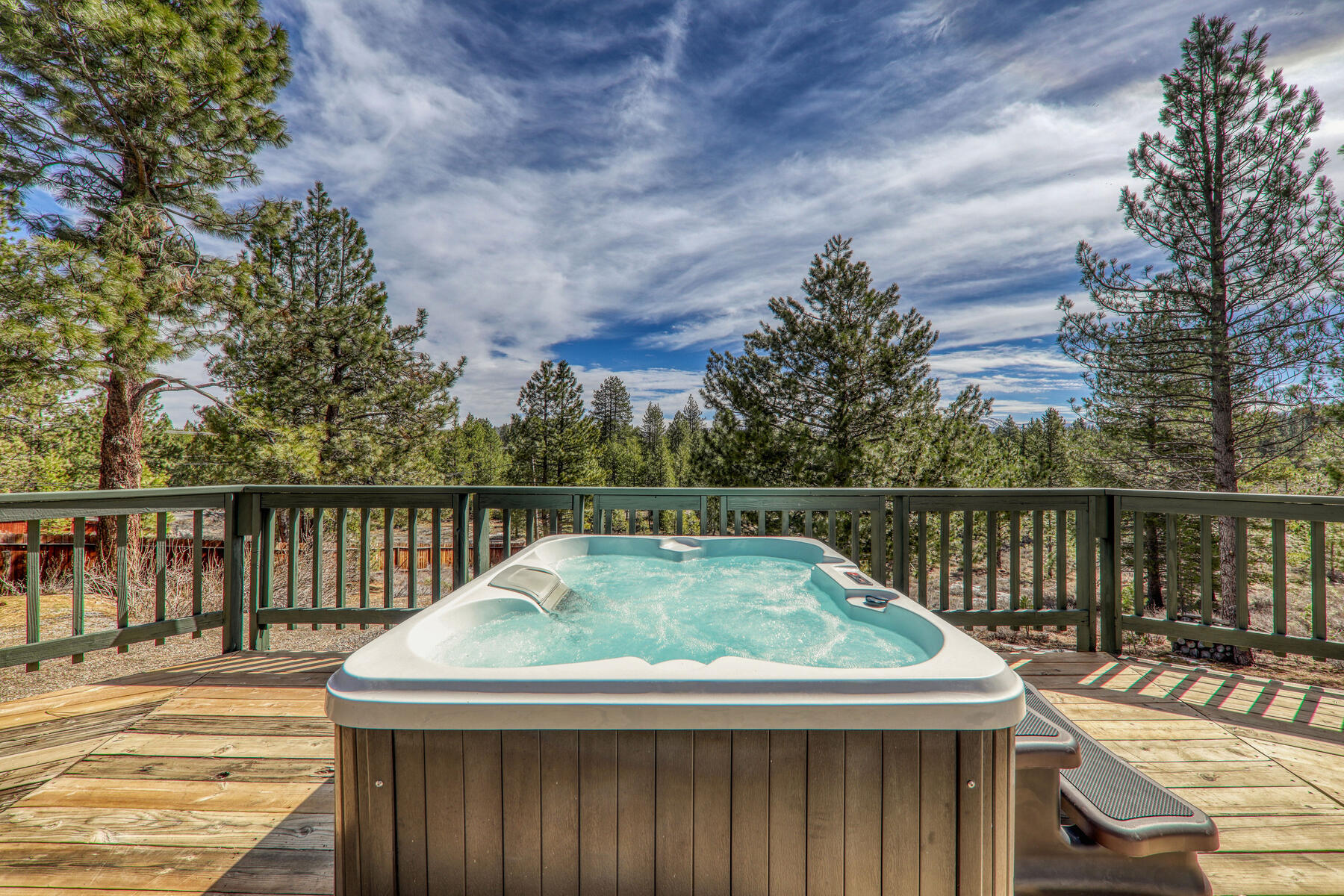 Hot tub on the deck into the pines